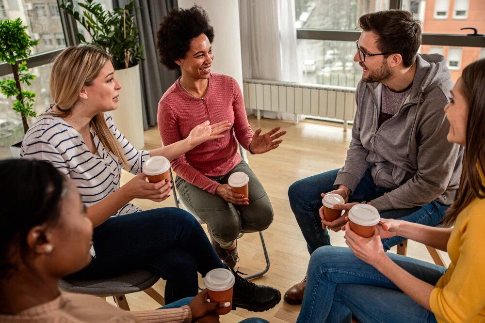 People Attending A Support Group Meeting As Part Of Their Long-Term Recovery Journey.